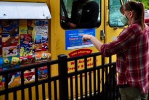 An lite prepcenter team member is seen making a selection at the ice cream truck provided by Ben's Natural Health.