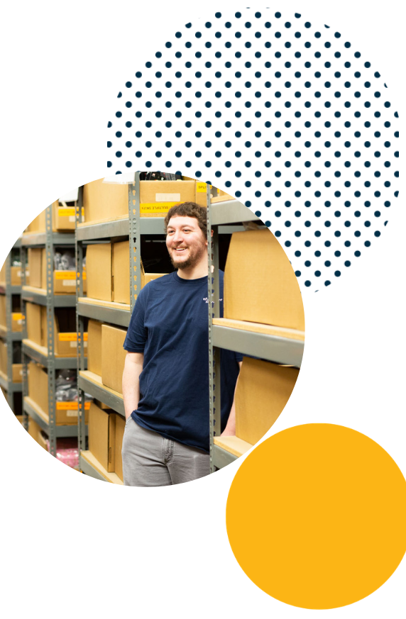 Lite PrepCenter Employee Young Male Smiling From Between Racks